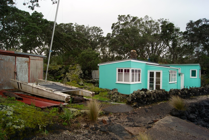 A bach with a boat shed at Rangitoto Wharf